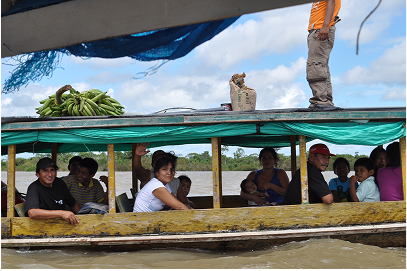 a passenger boat passes my own motorboat leaving the local town on the way back upriver.