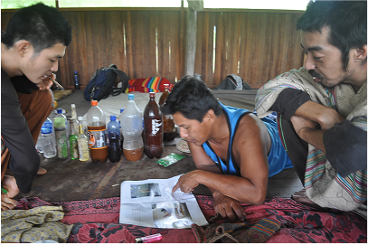After ceremony , maestro showing us an image from a shipibo cultural guide to Shamanic cosmology .